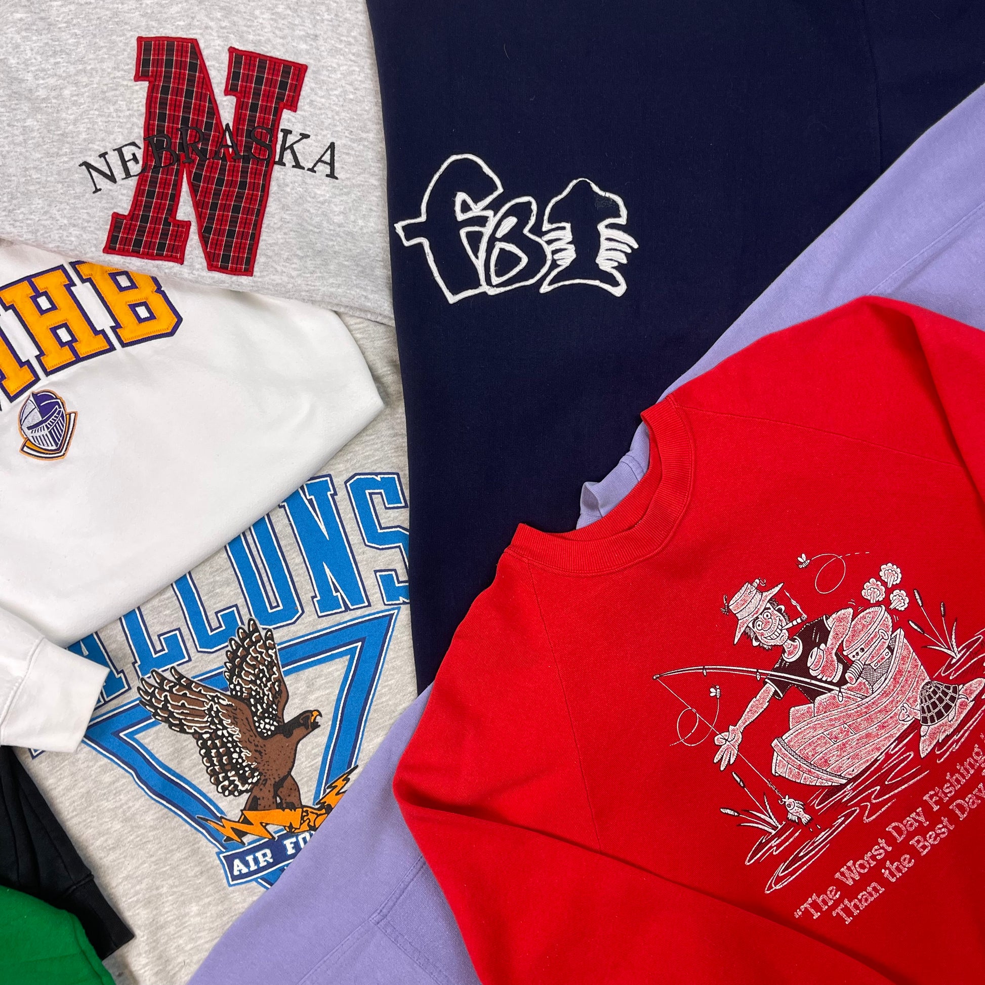 Collection of various t-shirts with different designs and text.